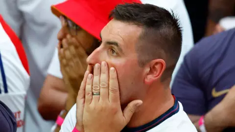 Action Images/Reuters Man in a crowd puts his hands on his face as he watches on