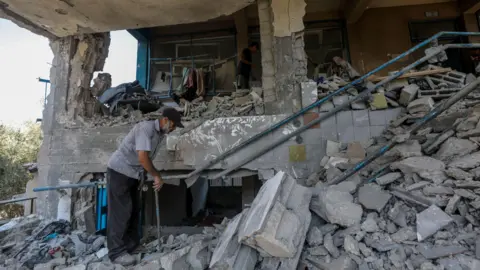 EPA A man surveys the damage at the Abu Oraiban School