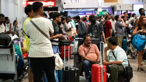 EPA Passengers wait to check in at Don Mueang International Airport in Bangkok, Thailand during the global IT outage