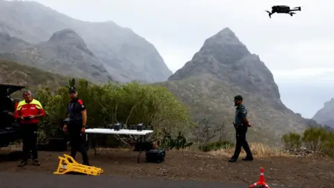 Reuters Search teams in the mountains where Jay Slater went missing