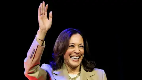 Reuters Kamala Harris waves and smiles