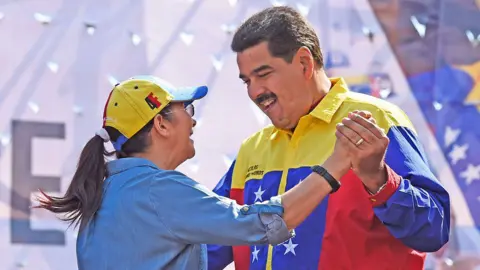 Getty Venezuelan President Nicolas Maduro (R) dances with his wife Cilia Flores during a demonstration against the United States' decision to renew sanctions on several top Venezuelan officials, in Caracas on March 12, 2016.