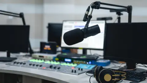 Getty Images Media equipment in the live room of a radio station - stock photo