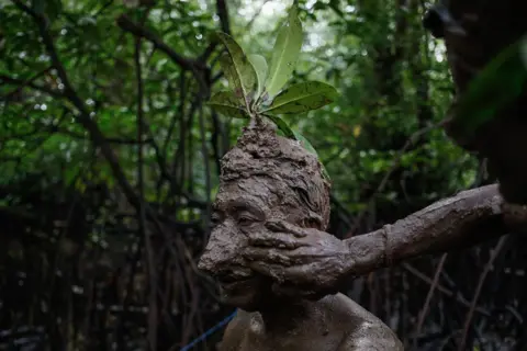 Johannes Panji Christo A local Balinese man is covered in mud during a bathing tradition, locally known as Mebuug Buugan, in Kedonganan village, just outside the town of Denpasar, Indonesia