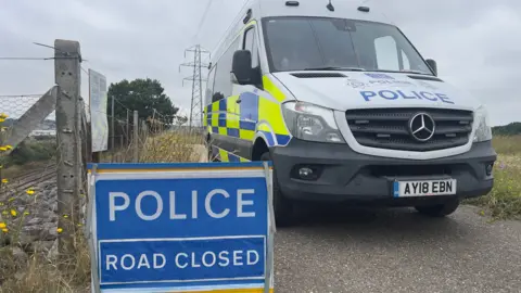 John Fairhall/BBC The cordon in place at Brantham near Rectory Lane