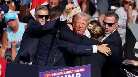 Reuters Trump punches a fist in the air after the assassination attempt