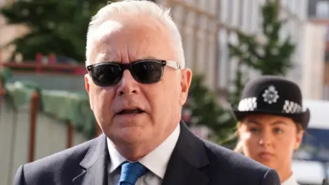 Reuters Former BBC news presenter Huw Edwards walks outside Westminster Magistrates' Court, ahead of his court hearing after being charged with indecent child picture crimes, in London, Britain, July 31, 2024