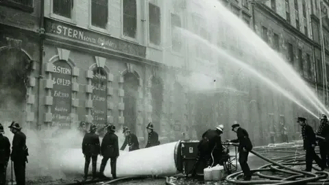 Getty Images Firefighters battle the fire at the Stern factory