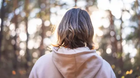 Getty Images young woman in a forest