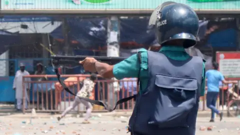 EPA A Police member reacts as demonstrators clash with police, Bangladesh Chhatra League (BCL) and Jubo League members, during ongoing quota students protests under the slogan 'Anti-Discrimination Student Movement' at Mirpur area in Dhaka, Bangladesh, 18 July 2024