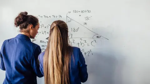 Getty Images Pupils doing maths on a whiteboard