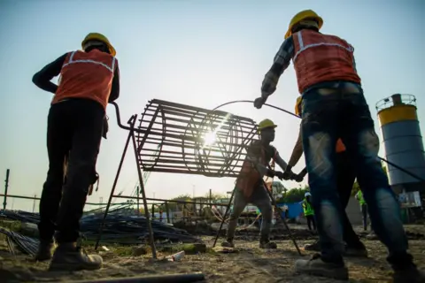 Getty Images Workers build the foundation at the construction site of Dixon Technologies Ltd.'s new factory, in Noida, India, on Friday, March 22, 2024. Dixon Technologies Ltd., an Indian contract manufacturer, is benefitting from a boom in new business from clients like Chinese smartphone maker Xiaomi Corp. and South Korea's Samsung Electronics Co. wishing to use its factories to manufacture goods for India's rising middle class