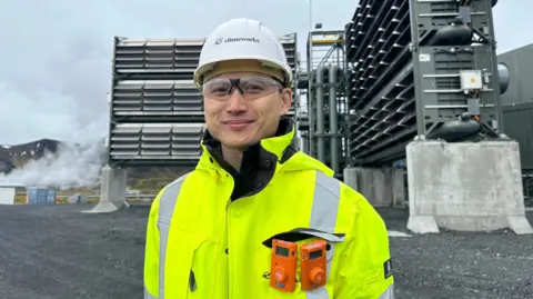 Climeworks’ Douglas Chan stands in front of large vents - part of the carbon capture plant