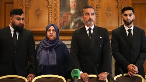 PA Media Amaad Amaaz (L) and Muhammad Fahir Amaaz (R) with mother Shameem Akhtar and solicitor Aamer Anwar