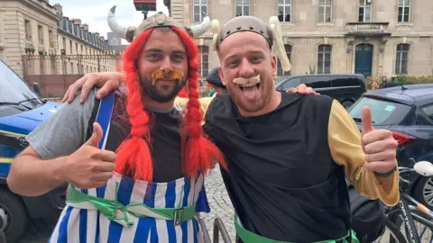 Two men dressed as comic characters Asterix and Obelix