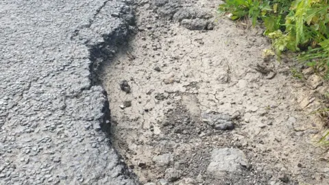 LDRS The pothole that damaged Mr Broadbent's car on a country road