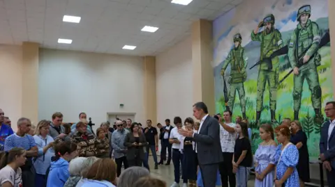 Reuters Vyacheslav Gladkov, governor of the Russian Belgorod region, talks to evacuees who left their homes following the Ukraine's advance into the area