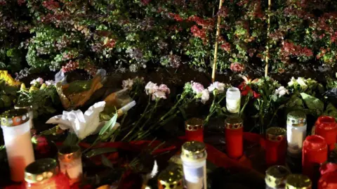  EPA-EFE/REX/Shutterstock Flowers and candles at the attack site in Solingen