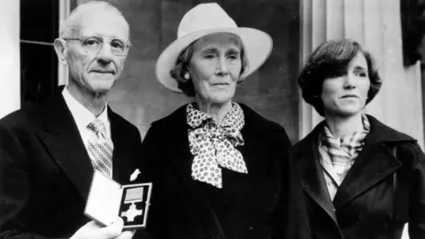 Getty Images Archive image showing Nairac's family, father Maurice with short grey hair and glasses, mother Barbara with white hat and scarf and sister Rosamonde with short dark hair and dark jacket