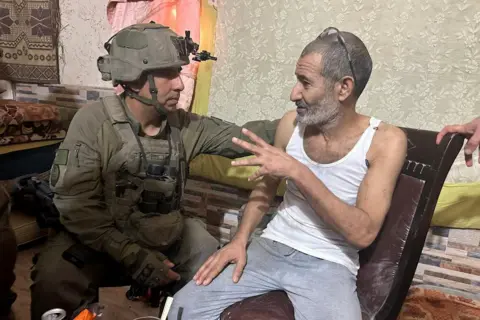 Reuters Israeli military handout photo showing Kaid Farhan Elkadi speaking to soldiers moments after his rescue in southern Gaza