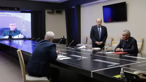 AFP via Getty Images Pool photograph distributed by Russian state owned Sputnik agency, Russia's Defence Minister Andrei Belousov (2nd L) and director of the Federal Security Service (FSB) of the Russian Federation, Alexander Bortnikov (3rd L) along with the Secretary of the Security Council of the Russian Federation, Sergei Shoigu listen to Chief of the General Staff of the Armed Forces of the Russian Federation, Valery Gerasimov (L) seen on a screen as he remotely joins a meeting with heads of law enforcement agencies to address the situation in the Kursk region, in Moscow, on August 7, 2024.