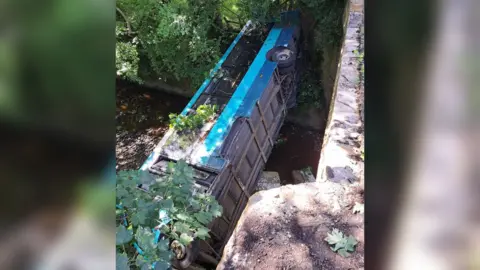 Scarborough and Ryedale Mountain Rescue A single decker bus hanging over a river