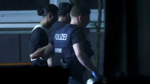 Reuters German police officers detain a man in Solingen late on Saturday. Photo: 24 August 2024