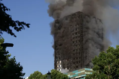 Getty Images Smoke billows from Grenfell Tower as firefighters attempt to control a huge blaze on June 14, 2017 in west London. The massive fire ripped through the 27-storey apartment block in west London, trapping residents inside as 200 firefighters battled the blaze.