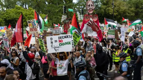 Getty Images A crowd protests in a city street