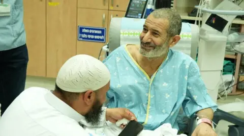 Reuters Israeli government handout photo showing rescued Bedouin hostage Kaid Farhan Elkadi speaking to relatives at Soroka Medical Center in Beersheba, Israel (27 August 2024)