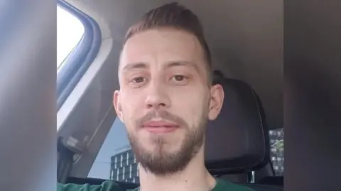 Cambridgeshire Police Man with beard sitting in car