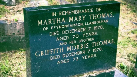 BBC News A grave headstone for Griff and Martha Mary Thomas, who was known as Patti