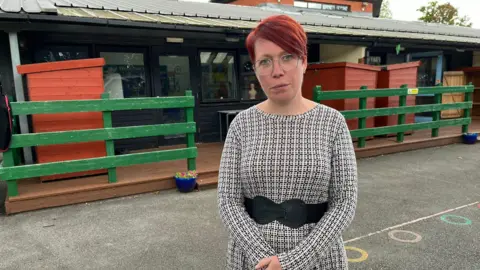 Parent and teacher Hayley Crew stands outside the school 