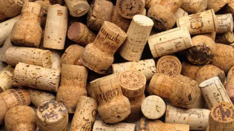 Getty Images A pile of corks from champagne and other wines. Some of the writing on them states Tattinger, Moet & Chandon and some have serial numbers on them too.