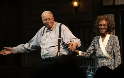 Getty Images James Earl Jones, pictured on the Broadway stage in 2015 wearing black trousers, a pinstriped shirt and braces, alongside his The Gin Game co-star, Cicely Tyson. 