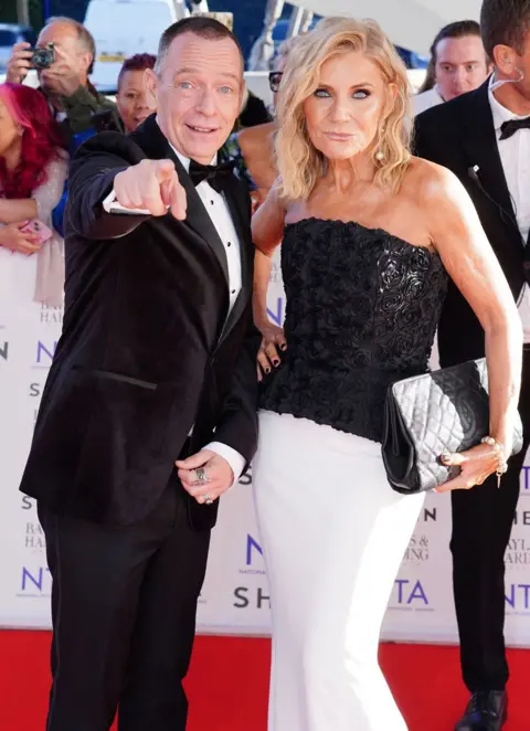 PA Media Adam Woodyatt and Michelle Collins