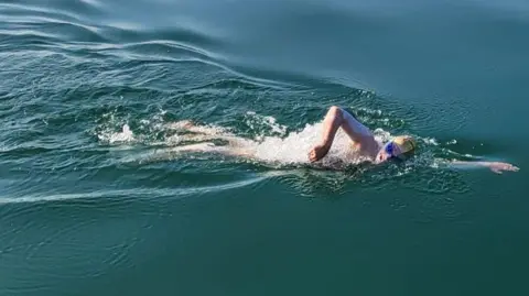 Sam Farrow/PA Wire Swimmer Sam Farrow in Lake Geneva 