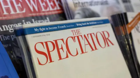 Bloomberg via Getty Images The 7 September 2024 edition of The Spectator magazine seen on a news stand, with other publications around it