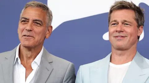 Reuters Cast members Brad Pitt and George Clooney pose during a photocall for the movie "The Wolfs" out of competition, at the 81st Venice Film Festival, Venice, Italy, September 1, 2024